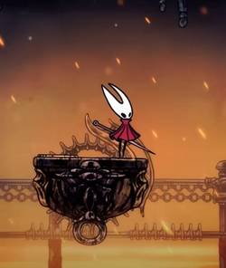 Hollow Knight: Silksong's protagonist Hornet sits on a moving platform amid a fiery landscape.